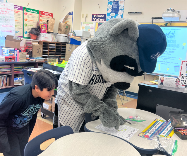 Renegades Mascot Rascal shows a student how to graph during Math Madness night at Morse Elementary 